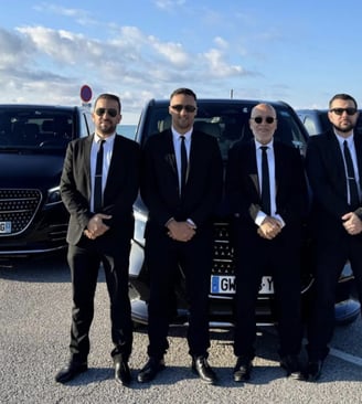 a group of men in suits and ties standing in front of a car
