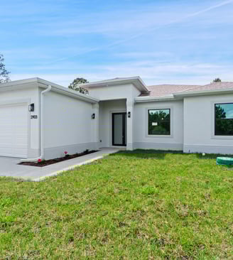 Beautifully designed front elevation of a new home for sale in Lehigh Acres, Florida. 3 beds + den,