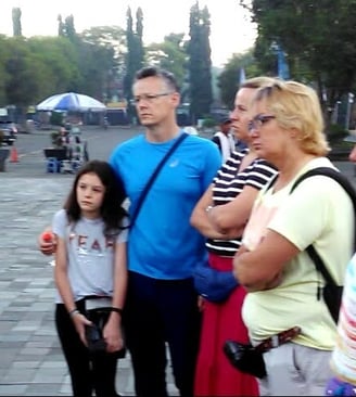a group of people standing in brief around a group of european client