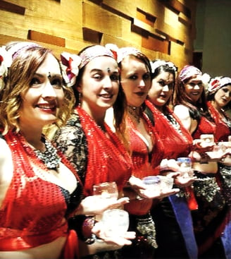 Ruby star bellydancers in red costumes performing candle dance in Utah