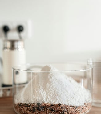 Premium Australian Skim Milk Powder in a clear container, showcasing its fine, white texture