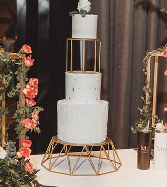 a cake with a gold frame and flowers