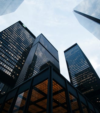 a group of tall buildings with a sky view of the city