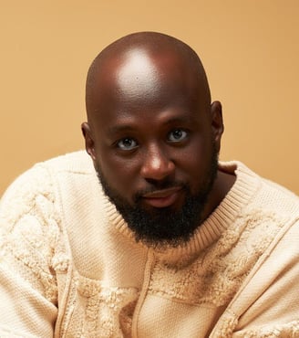 Kofi Karikari in a brown sweater.