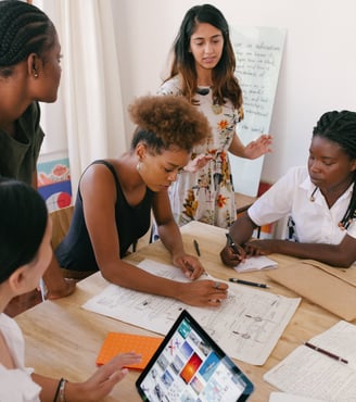 Diverse business women around a table scaling their business