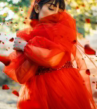 Empowered woman in red flowy dress, symbolizing a Phoenix rising as financial and spiritual freedom