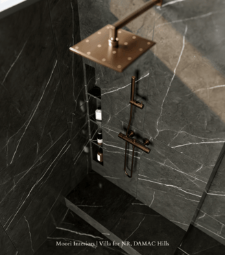 Luxurious shower detail featuring black marble shower walls with white veining and bronze fixtures