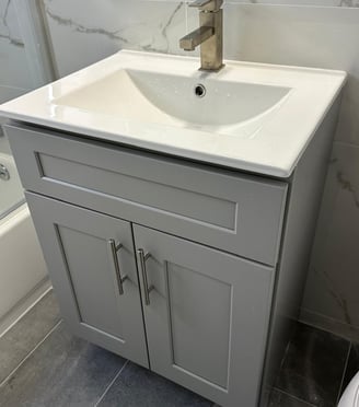 a bathroom sink with a white sink and a shower
