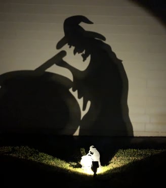 shadow of a witch stirring a cauldron