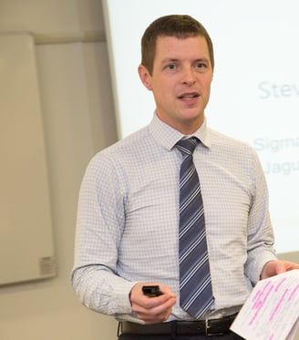 Steve Fannon presenting to a dinner audience in a previous role and organisation.