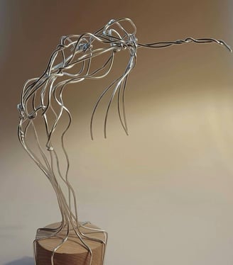 A wire sculpture of a complete female figure, standing, bending over backwards, arms out