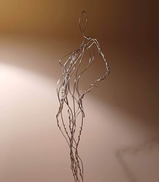 A wire sculpture of a complete female figure, standing with hands on hips