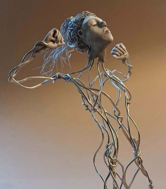 A wire sculpture of a complete kneeling female figure with clay hands, face and feet, arms raised