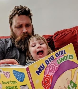 My toddler and I reading a book called My Big Girl Undies. My daughter looks jazzed, but I am studying intensely. 