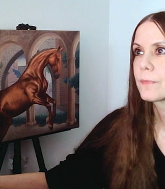 Carla Millar at desk with her oil painting in the background.