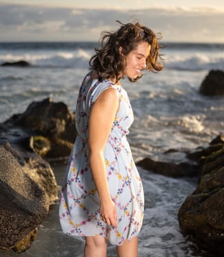 a woman in a dress standing in the water