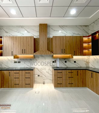 a kitchen with a marbled counter top and wooden cabinets