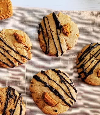 Biscoff-filled cookie styled with crumbs and drizzle