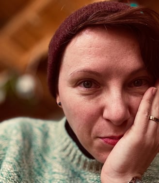 a woman with a red hat and a green sweater