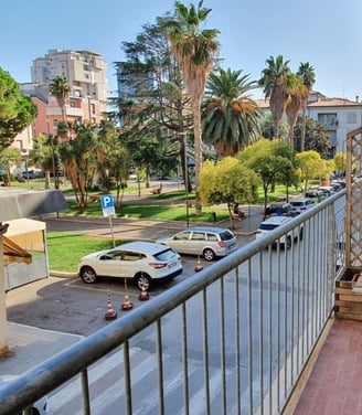 a balcony with a bench and a table with a chair