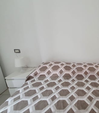 a bed with a bed and a nightstand with a lamp