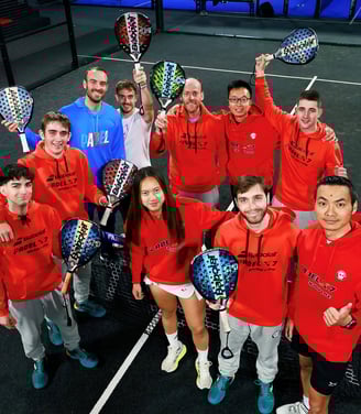 Group of padel coaches holding rackets at X7 Sabadell indoor courts