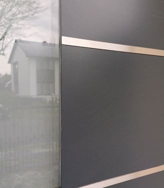 a black and white door with a window and a fence