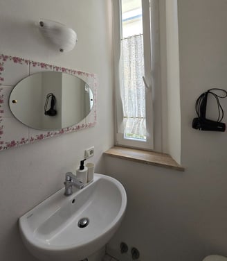 a bathroom sink with a mirror and a mirror