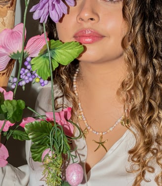 a woman with curly hair and a white shirt