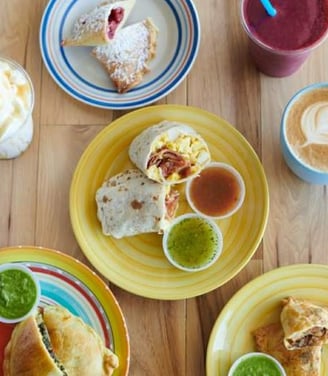 a spread showcasing our best selling coffee's, smoothies, frappes, empanadas, and burritos