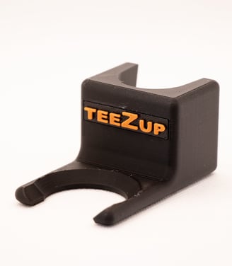 TeeZUP golf club attachment tee assist tool with orange wiriting on a white background