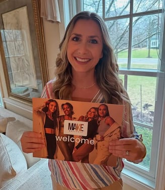 Woman posing with Make Wellness product literature. Welcome.