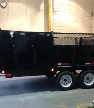 a black dumpster trailer with a black trailer