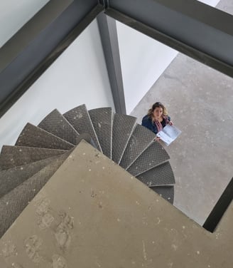 a woman sitting on a spiral staircase case
