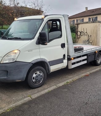 a truck with graffiti on it's side of the road