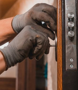 a person wearing gloves and gloves holding a keychain