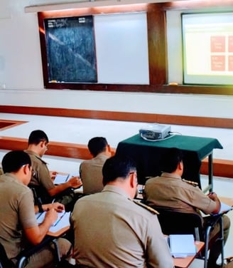 Trainer presenting to uniformed professionals during a classroom session.