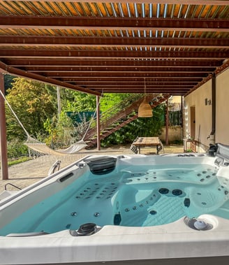 a hot tub tub in a backyard with a wooden deck