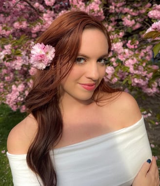 a woman with a flower in her hair — headshot of Amanda Townes