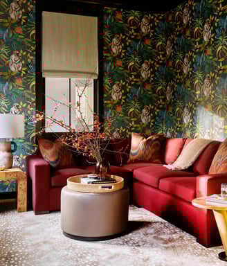 colorful living room, red couch, tropical wallpaper