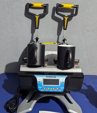two magic mugs siting on a mug press