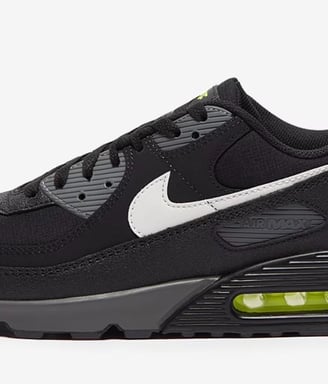 Nike Air Max 90 sneakers in black with neon yellow accents, visible Air cushioning, and mesh upper