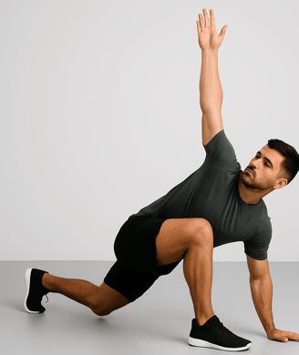 a man in a gray shirt is doing a yoga pose