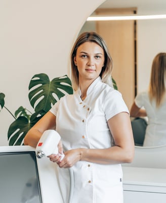 a woman in white shirt and white shirt holding a hair dryer