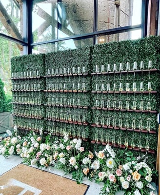 3 Champagne walls with flowers and greenery in the entrance of venue