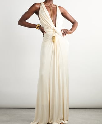 Elegant ivory draped gown with deep plunge neckline – luxury evening wear fashion statement.