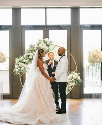 a bride and groom standing in front of a wedding ceremony