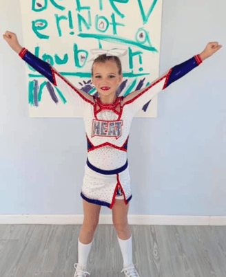 baylor in a cheer pose her first season