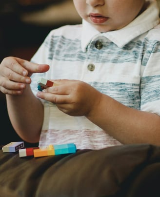 a young boy playing with blocks and blocks