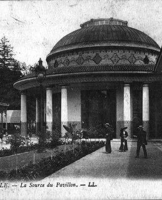 a black and white photo of a building with a dome shaped building